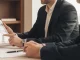 Asesor empresarial atendiendo reunión con cliente en despacho de asesoría para sociedades en Tabernes Blanques con tablet.